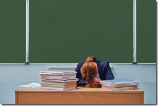 Woman teacher sleeps with head resting, copy space. Tired school teacher against a green blackboard, closeup