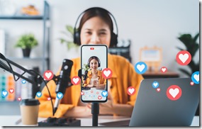 \Vlogger live streaming podcast review on social media, Young Asian woman use microphones wear headphones with laptop record video. Content creator concept.