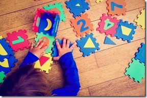 little girl playing with puzzle, early education