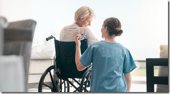 Old woman in wheelchair, care or caregiver talking for healthcare support at nursing home. Back, view or happy nurse speaking to senior patient or elderly person with a disability for empathy or hope