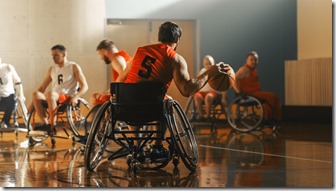 Wheelchair Basketball Game Court: Active Professional Player Dribbling Ball, Prepairing to Shoot and Score a Goal. Determination, Inspiration, and Skill of a People with Disability.