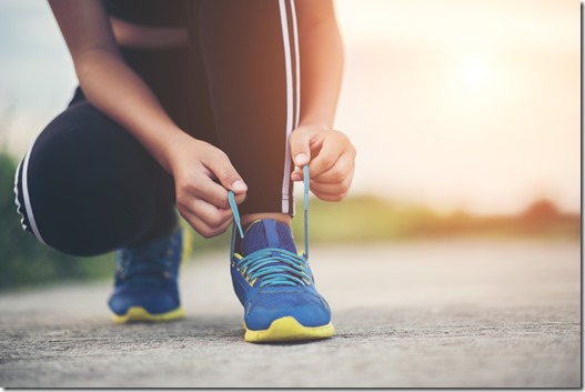 Close up shoes Female runner tying her shoes for a jogging exercise