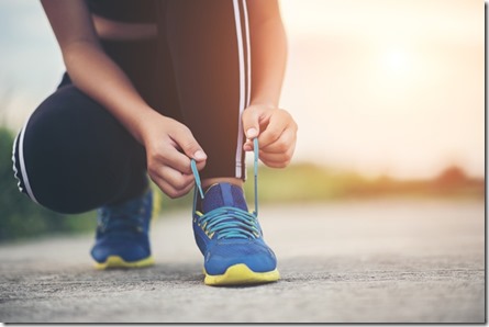 Close up shoes Female runner tying her shoes for a jogging exercise