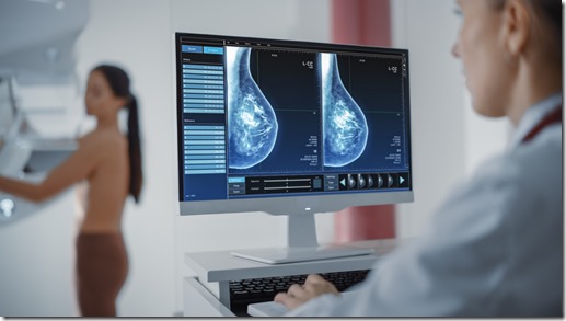 Computer Screen in Hospital Radiology Room: Beautiful Multiethnic Adult Woman Standing Topless Undergoing Mammography Screening Procedure. Screen Showing the Mammogram Scans of Dense Breast Tissues.