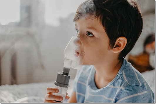 sick child breathes in a nebulizer