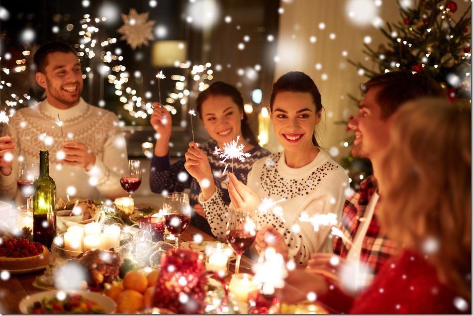 happy friends celebrating christmas at home feast