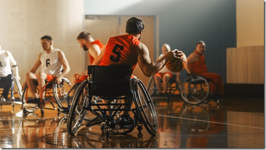 Wheelchair Basketball Game Court: Active Professional Player Dribbling Ball, Prepairing to Shoot and Score a Goal. Determination, Inspiration, and Skill of a People with Disability.